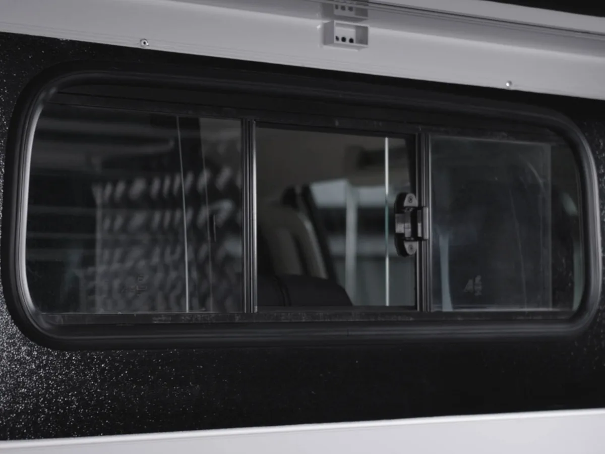 The cab slider window fitted to the front panel of a Bushtech canopy, seen from outside