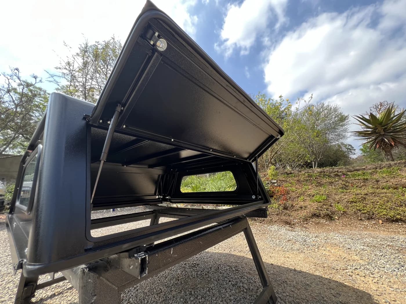 A gullwing door held open on its gas strut