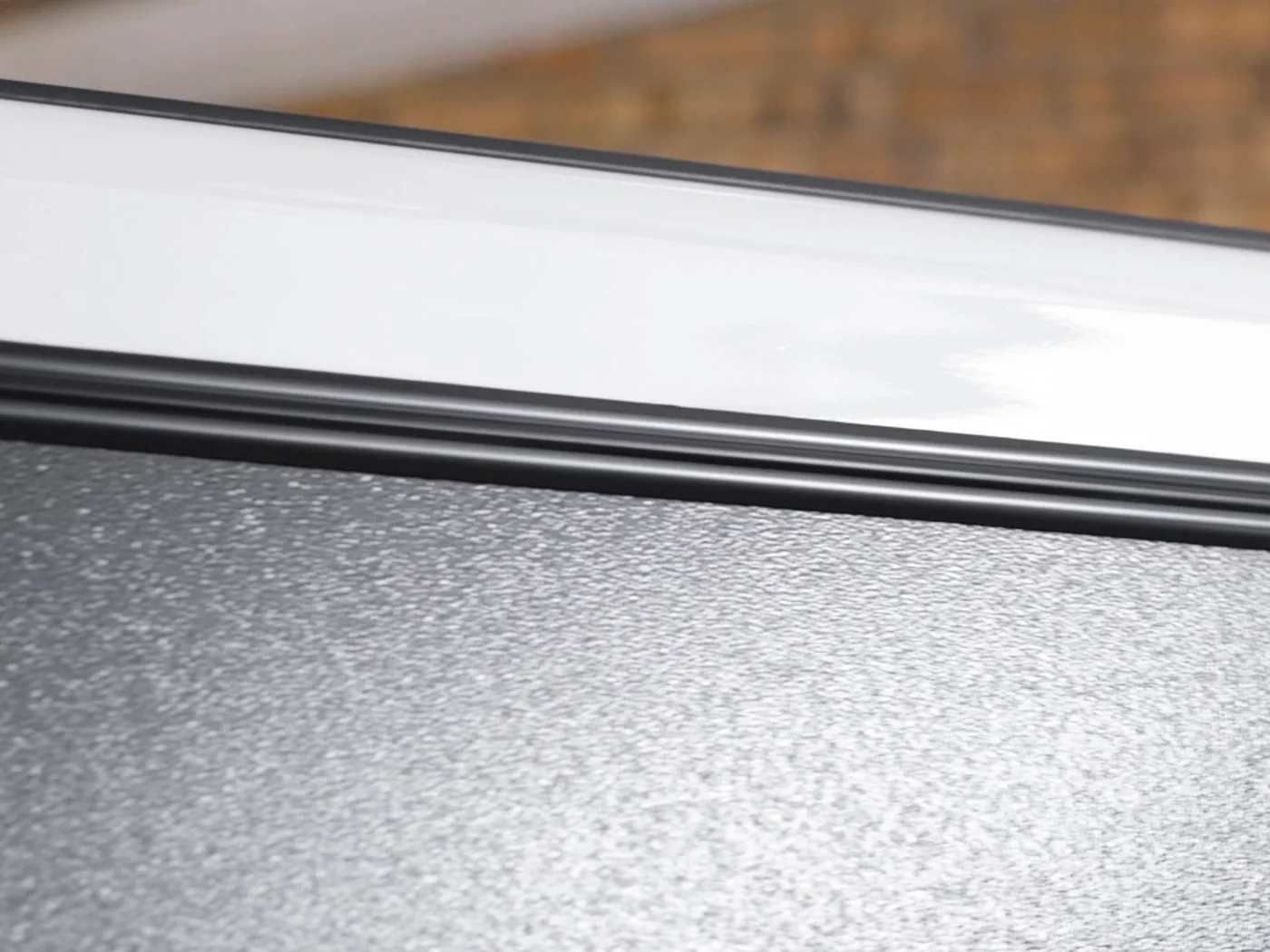 The continuous full-length hinge along a Bushtech canopy door