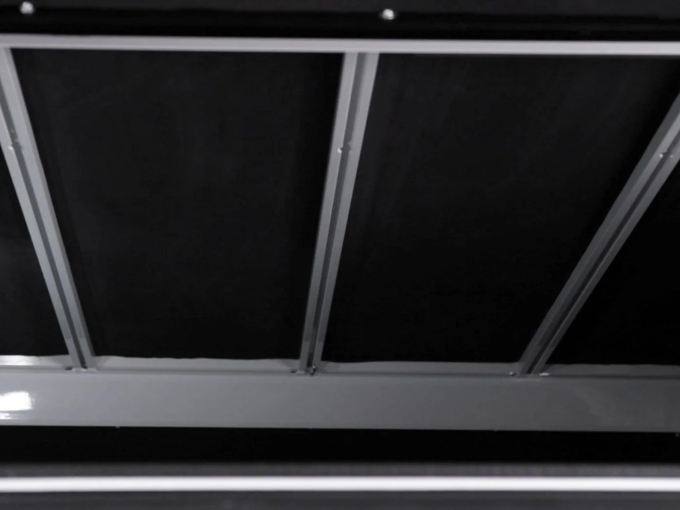 Slotted roof rails running the length of the canopy roof, from inside