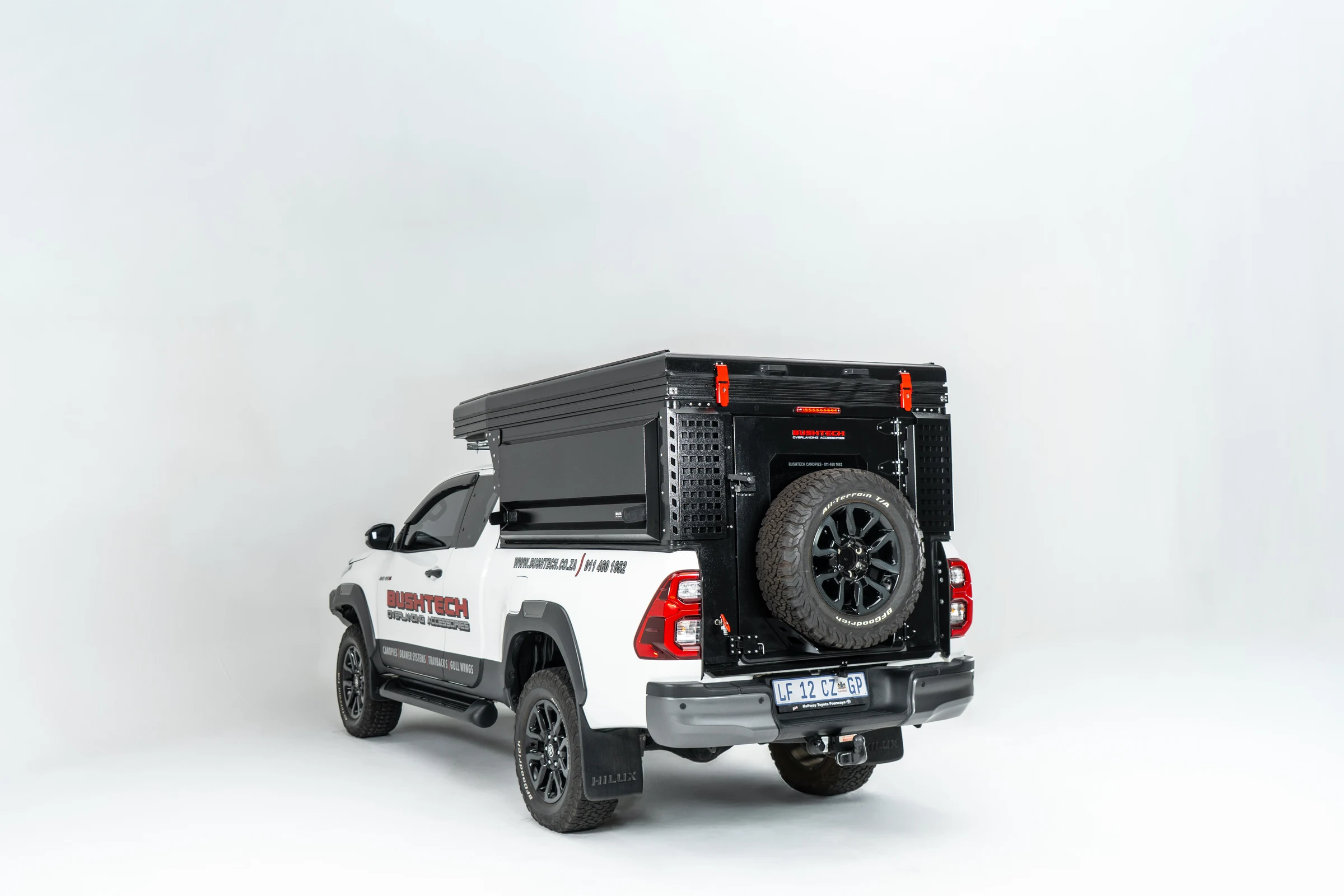 White Toyota Hilux Revo extra cab fitted with a Bushtech Bush Cabin, photographed on a white studio background